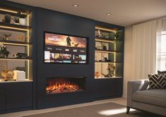 a living room with a couch, fireplace and entertainment center in the middle of it