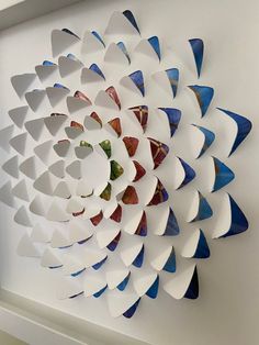 an art piece made out of white and blue paper