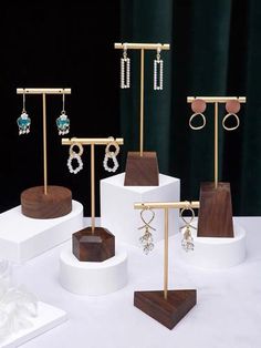 several different types of earrings on display