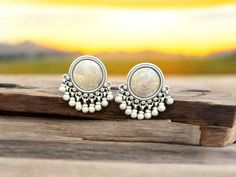 Add a touch of elegance to your ensemble with these handmade sterling silver stud earrings featuring hanging silver balls. Weighing 19.60 grams each, these unique earrings have a width of 2.5 cm and a drop length of 3.7 cm. Perfect for any occasion, their exquisite design showcases the skilled craftsmanship of our artisans. Measurements:     Weight: 19.60 grams     Width: 2.5 cm     Drop Length: 3.7 cm For more products, please visit our shop at https://surrekhacollections.etsy.com Traditional Silver Round Bead Earrings, Silver Round Clip-on Earrings For Festive Occasions, Boho Stil, Sterling Silver Studs, Sterling Silver Earrings Studs, Showcase Design, Handmade Sterling Silver, Exquisite Design, Unique Earrings