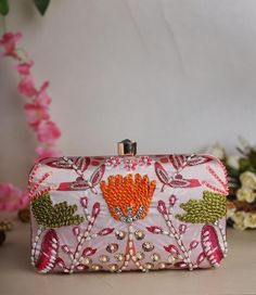 Elevate your evening look with this elegant clutch bag for women, perfect for weddings, parties, or formal events. Handmade with luxurious exterior in a vibrant odaek green hue, this clutch features a convenient clasp closure and a chain for easy carrying. The ethnic theme adds a touch of cultural charm, making it a versatile accessory for both casual and dressy occasions. Add this unique piece to your collection for a stylish statement. Flower Clutch, Zardozi Work, Sequin Embroidery, Sequins Embroidery, Purple Hues, Purse Bag, Pink Flower, Summer Party, Clutch Purse