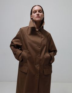 Made from high-quality material, this trench coat guarantees a unique look with its deep brown colour. A straight cut with clean lines and structured details create a sophisticated silhouette, complementing your look with every move.Buttons trimmed in the same colour as the base material add extra elegance and style to the trench coat. This trench coat is not just an outfit - it is an expression of your personality and understanding of true style. Dense material protects from the wind.Material 1 Brown Long Coat For Office, Chic Brown Gabardine Outerwear, Modern Brown Outerwear For Business, Modern Brown Outerwear For Office, Modern Brown Business Outerwear, Brown Outerwear With Concealed Placket For Work, Brown Workwear Outerwear With Concealed Placket, Brown Gabardine Long Coat, Brown Gabardine Fall Outerwear