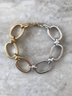 This thick bracelet is half rhodium, part of the platinum family, and half brass with a thick 24k gold overlay. The bracelet has a gold fill lobster clasp and extension so that it can be adjusted to size.Length: 6.5 inchesExtension: 1 inchchromatic bracelet, gold bracelet, silver bracelet, mixed metal bracelet, bracelet, gold jewelry, silver jewelry, gift, gift for her,holiday Mixed Metal Bracelet, Gold Arm Band, Mixed Metal Bracelets, Gold Schmuck, Mixed Metal Jewelry, Gold Armband, Metal Bracelet, Gold Overlay, Gold Choker