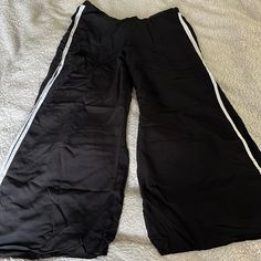 Nwot - High Cut Slits - Elastic Back Waist - Rayon Non Stretch Breezy Fabric 15”-17” Waist 10” Rise 21.5” Hip 27” Inseam 22.5” Slits Sporty Black Wide Leg Pants For Spring, Wide Leg Bottoms With Side Stripes For Spring, Wide Leg Bottoms With Side Stripes For Loungewear, Wide Leg Loungewear Bottoms With Side Stripes, Black Wide-leg Summer Capris, Black Pants With Side Stripes For Spring, Casual Black Wide-leg Capris, Spring Black Pants With Side Stripes, Black Bottoms With Side Stripes For Spring