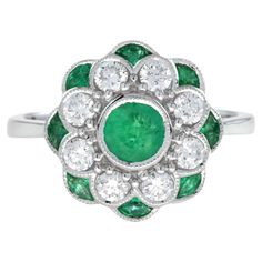 With a gorgeous design that includes an emerald center with diamond and emerald petals of peony flower design, this art-deco style ring is ready to bloom on your finger. Ring Information Style: Art Deco Metal: 18K White Gold Weight: 5.40 g. (approx. total weight) Center Gemstones Type: Emerald Shape: Round Size: 4.8 mm. Number: 1 Weight: 0.60 Carat (approx. total weight) Accent Gemstones I Type: Emerald Shape: Marquise Size: 4 x 2 mm. Number: 8 Weight: 0.70 Carat (approx. total weight) Accent Gemstones II Type: Diamond Average Color: H Average Clarity: SI Shape: Round Size: 2.5 mm. Number: 8 Weight: 0.56 Carat (approx. total weight) This ring will be made to your order in 1-2 weeks, contact us to find out more. An attractive ring box is included.  Most of our rings can be sized to any fing Peony Flower Design, Art Deco Metal, Number 8, Estilo Art Deco, Art Deco Diamond, Peony Flower, Finger Ring, Emerald Diamond, Jewelry Rings Engagement