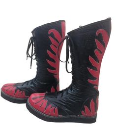 Step into the ring with confidence and style wearing our Handmade  Leather Wrestling Boots. Crafted with 100% genuine leather, these boots boast not only unparalleled durability but also a unique and luxurious aesthetic. The striking RED color is accentuated by a fire-style leather layer, adding an extra dimension to your wrestling attire. Black Textured Leather with Red Fire Style.  Designed for optimum performance, these boots feature a lace-up style, allowing for a secure and customizable fit High-top Leather Boots For Festival, Red Lace-up Leather Moto Boots, Red Leather Lace-up Moto Boots, Wrestling Attire, Wrestling Boots, Luxurious Aesthetic, Handmade Leather Shoes, Black Textures, Long Boots