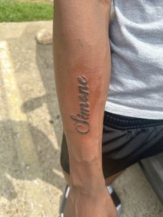 a person with a tattoo on their arm that says,'smile'in cursive writing