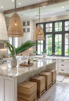 a large kitchen with white cabinets and marble counter tops, an island in the middle