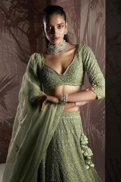 Mint green lehenga with bead and crystal embellished scallop motifs. Comes with embellished blouse and cut-out hem dupatta.
Components: 3
Pattern: Embroidered
Type Of Work: Sequin,Crystal
Neckline: V-neck
Sleeve Type: Three quarter 
Fabric: Blouse and Lehenga: Net, Dupatta: Organza 
Color: Green
Other Details: 
Bead tasselled blouse
Closure: Lehenga: Side Drawstring
Occasion: Bride,Wedding - Aza Fashions Mint Green Lehenga, Tassel Blouse, Green Lehenga, Sequin Blouse, Bridal Lehengas, Embellished Blouse, Net Dupatta, Green Blouse, Beaded Tassels