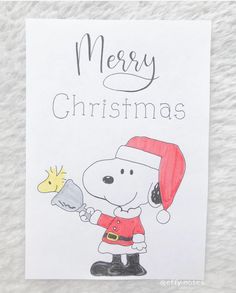 a hand drawn christmas card with a cartoon character holding a cookie and wearing a santa hat