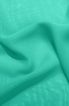 a close up shot of the fabric in turquoise green, which is very soft and smooth