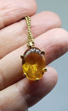 This beautiful vintage faux amber (glass) stone pendant from Monet is set in a domed cabochon which dangles from a small cable chain. The amber glass pendant measures 5/8 inches tall by almost 1/2 inch wide. It is a clear setting, which allows light to come through the gold glass stone. The necklace measures 16 inches long, but has a built-in extension of 2 inches. There are numerous markings to let you know this is Monet jewelry - the lobster claw clasp, the attached cartouche with a small rhin You're Special, Monet Jewelry, Roman Glass, Vintage Monet, Glass Pendant Necklace, Shiny Things, Gold Glass, Amber Glass, Stone Pendant