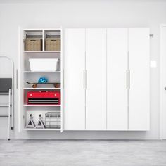 a white room with some cabinets and other items in it's storage unit area