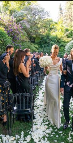 the bride and groom are walking down the aisle