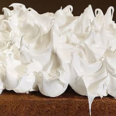 a piece of cake with whipped cream on top