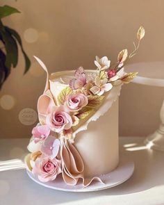 a white cake with pink flowers on top