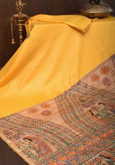 Experience the classic sophistication of a Beige Semi Tussar Silk saree. This timeless garment features a Madhubani Gecha Tussar Pallu and a fine Zari Border, joining rustic Tussar silk and Madhubani art in a wonderfully unique piece. The Sulphur Yellow hue of the fabric creates an elegant ackdrop for the captivating motifs of the Madhubani Gecha Tussar Pallu. The tasteful Zari Border adds an extra layer of elegance, turning this saree into a stunning piece of art - perfect for cultural celebrat Traditional Yellow Raw Silk Pre-draped Saree, Yellow Anarkali Unstitched Suit In Slub Silk, Yellow Anarkali Unstitched Slub Silk Suit, Yellow Anarkali Slub Silk Unstitched Suit, Traditional Yellow Slub Silk Unstitched Suit, Yellow Kalamkari Print Kurta For Festive Season, Yellow Kalamkari Print Kurta For Festive Occasions, Festive Yellow Kurta With Kalamkari Print, Traditional Yellow Slub Silk Blouse Piece