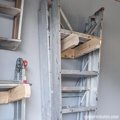 there is a ladder that has been built into the side of a wall with wood planks on it