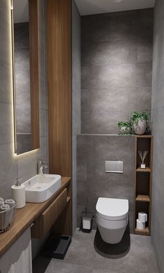 a bathroom with a toilet, sink and mirror in it's center wall is shown