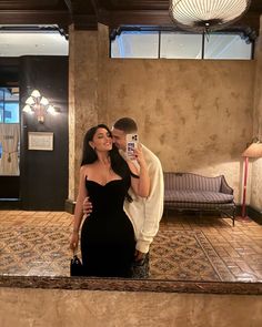 a man and woman taking a selfie in a hotel lobby