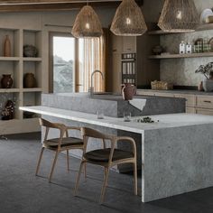 a large kitchen with an island counter and chairs