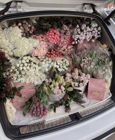 the trunk of a car filled with flowers