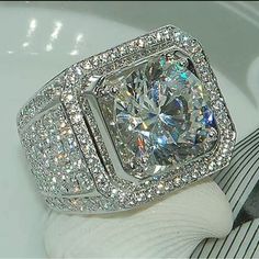 a diamond ring sitting on top of a white plate