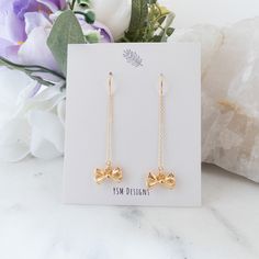 Embrace simplicity with these understated bow earrings, showcasing miniature gold-plated bow charms suspended from elegant gold threader earrings. Crafted with high-quality gold-plated threader chains, these dangling ribbon earrings are both stylish and lightweight, making them an ideal choice for everyday wear. Radiate charm and versatility with these gold ribbon ear threads, making them a perfect gift for teen girls or anyone with an affinity for the timeless elegance of bows Details:--------- Gold Threader Earrings, Ribbon Earrings, Ear Threader, Threader Earrings Gold, Bow Ribbon, Gold Ribbon, Bow Earrings, Gold Ribbons, Threader Earrings