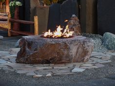 a fire pit sitting on top of a stone walkway