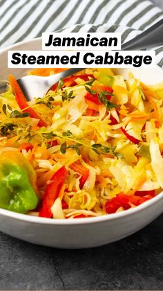 a bowl filled with coleslaw and vegetables on top of a table