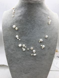 "quantity: 1 strand pearl jewelry:  floating pearl necklace pearl body: please look at picture necklace length: 17.5 inches pearl grade:AA pearl luster:high pearl shape: nugget pearl color: white ---All style of illusion necklace--- https://www.etsy.com/hk-en/shop/WenPearls?ref=hdr_shop_menu&search_query=NPN3 Back to Other Jewelry Section 01: \"Tahitian,Akoya,Sea Pearl\" Section: https://www.etsy.com/shop/WenPearls?section_id=15806339 02: \"Potato/Near Round Pearl\" Section: https://www.etsy.com White Double Strand Pearl Necklace For Party, White Pearl Chain Layered Necklace For Wedding, White Double Strand Pearl Layered Necklace, White Pearl Double Strand Layered Necklace, Leather Pearl Jewelry, Illusion Necklace, Floating Pearl Necklace, Leather Pearl Necklace, Picture Necklace