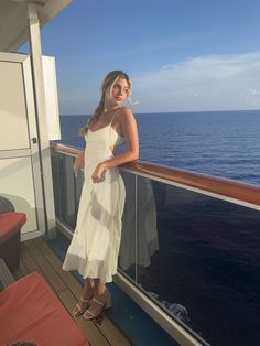 a woman standing on the deck of a cruise ship