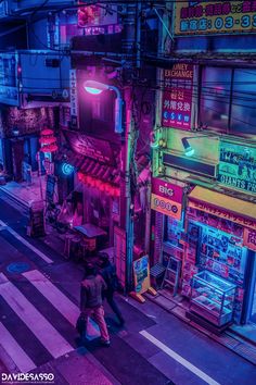 a man walking down the street in front of a store with neon signs on it