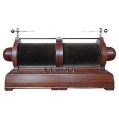 an old fashioned wooden machine with metal handles