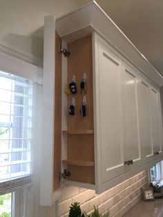 a kitchen with white cabinets and tile backsplash