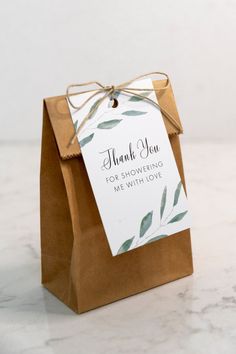 a brown paper bag with a thank you tag tied to the front and back of it