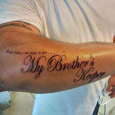 a man with a tattoo on his arm that says, my brother's keeper