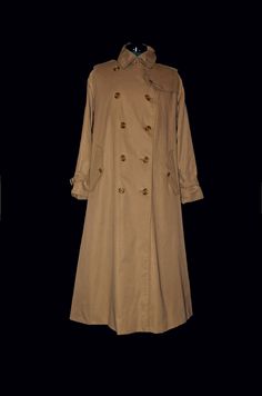 "Burberrys vintage, classic trench coat, camel color, khaki, full length, designer coat, Burberrys raincoat, high fashion, luxury outer wear  vintage Burberrys' trench coat  made in England   51% cotton  49% polyester outer shell inside lining - 100% cotton  size 12 long classic Burberrys trench coat made in England camel khaki beige color full length designer coat winter coats weatherproof Features: epaulettes,                   wedge back                    storm flap                  double b Long Coat Men, Luxury Outerwear, Burberry Trench, Burberry Trench Coat, Classic Trench Coat, Outer Wear, Rain Coat, Coat Design, Camel Color