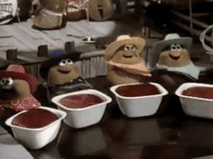 several cartoon characters are sitting in front of bowls of chili and sauces on a table