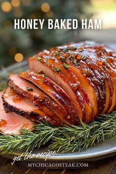 sliced ham on a platter with rosemary garnish and text that reads honey baked ham