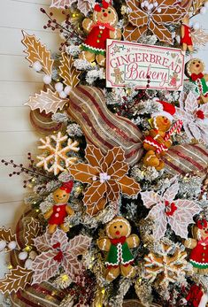 a christmas tree decorated with gingerbreads and other holiday decorations