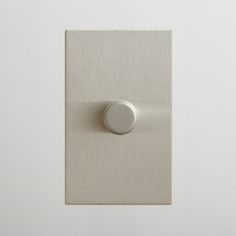 a white light switch on a wall in a room