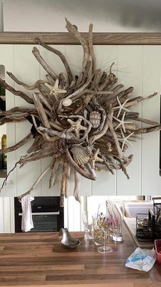 a wooden table topped with lots of driftwood