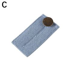 a button that is sitting on top of a blue piece of cloth with the letter c in it