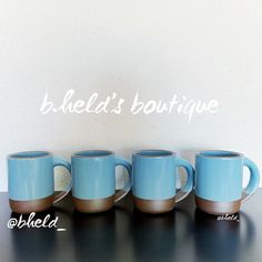 three blue coffee mugs sitting on top of a table