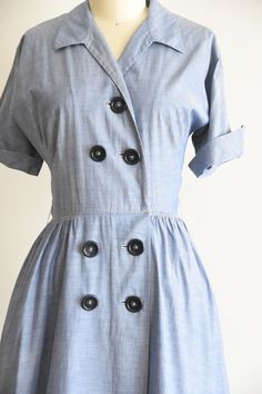 "Vintage early 1950s daydress. Chambray cotton, pointed collar, fold over sleeves, triple darted bust and nipped waist. Hidden side pockets. Free skirt. Loops for belt, missing belt. Front button closure. State of garment | very good, light overall wear and one itty hole on bodice and faint spot on skirt and collar. Measurements ✂--- Best fit | Small Bust | up to 38/39\" Shoulders | not specified Shoulder to waist | 16\" Sleeves | aprox 9\" Waist | 25\" Hips | free Total length (shoulder to hem) Vintage Belted Workwear Dresses, Vintage Belted Dresses For Work, Vintage Cotton Dress With Buttons, Cotton Vintage Dress With Buttons, Vintage Cotton Dress With Buttons For Daywear, Vintage Fashion Cotton Dress With Buttons, Vintage Cotton Workwear Dresses, Vintage Cotton Dresses For Work, Cotton Vintage Dress With Buttons For Daywear