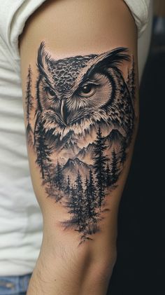 an owl with trees and mountains in the background is shown on this woman's thigh