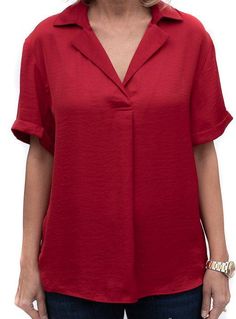 Take a look at our beautiful Ruby Red Notch Collar Short Sleeve Blouse Soft silky fabric Super soft 100% microfiber fabric Color: Ruby Red Semi loose body with short sleeves Notch collar with a pleat detail in the front Back has a yoke and decorative small buttons Center back length is 25" Solid V-neck Viscose Blouse, Red Relaxed Fit Blouse For Work, Solid Color Short Sleeve Relaxed Fit Blouse, Solid Color Short Sleeve Blouse With Relaxed Fit, Solid Color Relaxed Fit Short Sleeve Blouse, Relaxed Fit Solid Color Short Sleeve Blouse, Elegant Short Sleeve Solid Color Blouse, Versatile Short Sleeve Solid Color Blouse, Elegant Short Sleeve Blouse In Solid Color