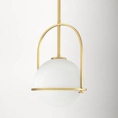 a white and gold pendant light hanging from a ceiling fixture in a living room or dining room