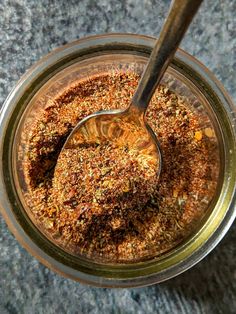 a spoon in a jar filled with spices